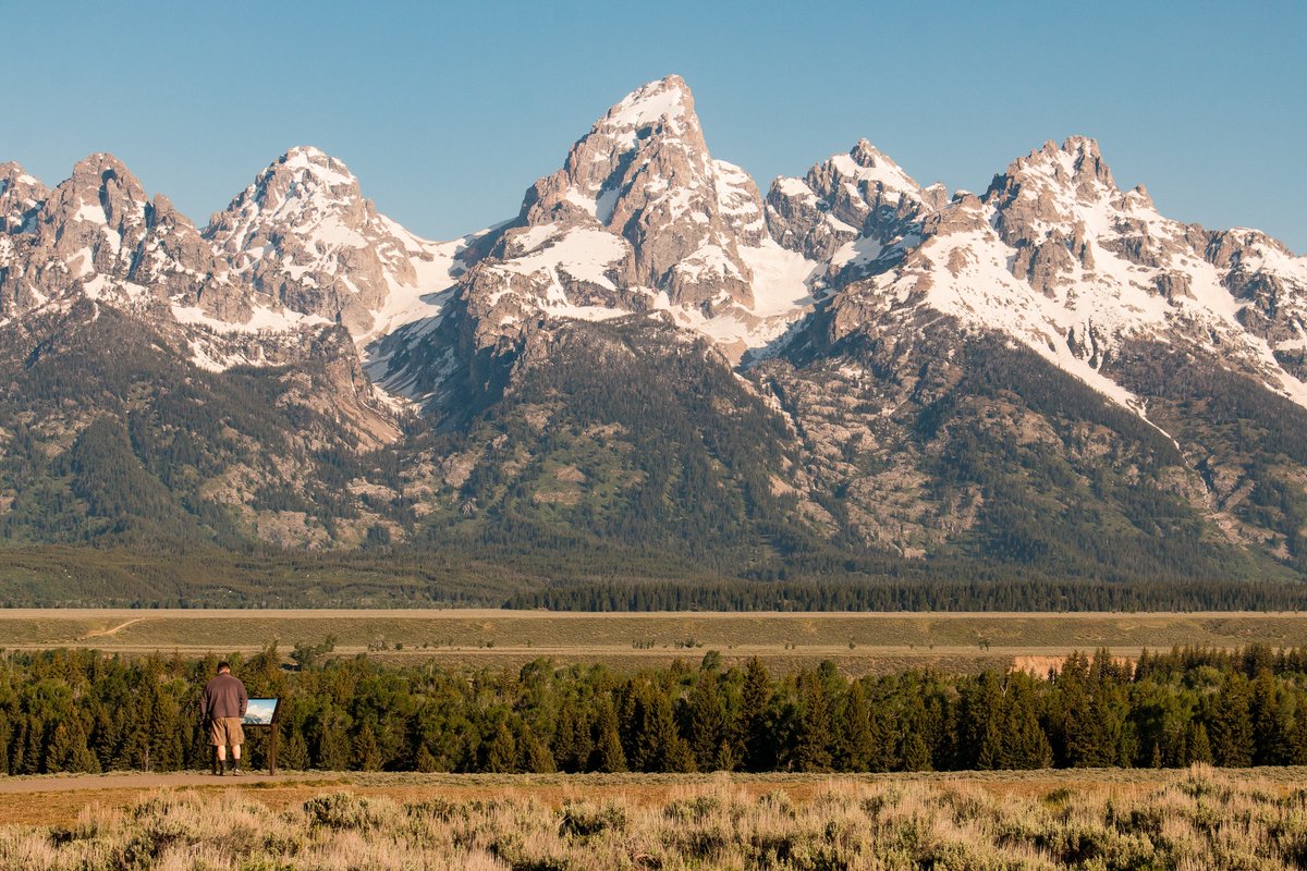 YellowstoneNPS's tweet photo. Being the first national park, we often hog the spotlight. So, we wanted to highlight our friends at surrounding parks, forests, wildlife refuges, and more!

Here's just a very small sample of the beauty and history you can experience outside of the park boundary. Have you visited a nearby area that inspired you?

If you're looking for ideas of nearby areas to visit, our website is a great place to start: https://t.co/7nSdR5Te1T

Photos: (1) Hiking in Custer-Gallatin National Forest near the Beartooth Highway (road is tentatively scheduled to open May 22); (2) Hiking into a lava tube cave at Craters of the Moon National Monument and Preserve; (3) Mountain views at Grand Teton National Park; (4) Rainbow at Bear Paw Battlefield at Nez Perce National Historical Park.