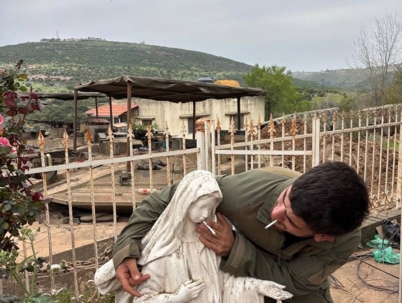 📌 In southern Lebanon, an Israeli soldier placed a cigarette in the mouth of a statue of the Virgin Mary.