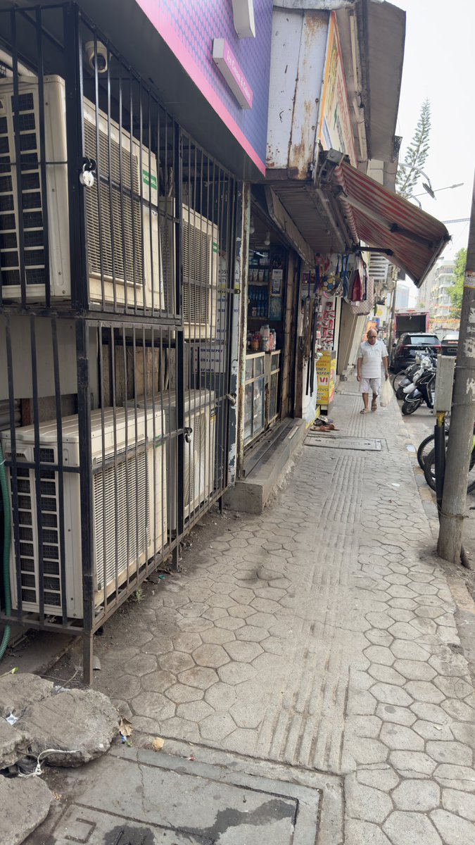 RRanshinge's tweet photo. @mybmc kw ward Lokhandwala Vyapari mandal &amp; shopkeeper-who park their cycle and motorcycle taking the road space along with all the ACs facing on the footpath with the hot air. How do a citizen walk? https://t.co/EcpkrEt9XX