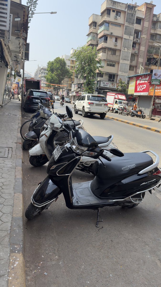 RRanshinge's tweet photo. @mybmc kw ward Lokhandwala Vyapari mandal &amp; shopkeeper-who park their cycle and motorcycle taking the road space along with all the ACs facing on the footpath with the hot air. How do a citizen walk? https://t.co/EcpkrEt9XX
