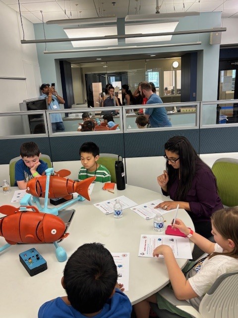 NovaEngineer's tweet photo. Deeksha Seth, PhD, assistant professor of ME, welcomed students from Walton Farms Elementary’s AI Club to campus for a hands-on engineering experience. Students explored labs, the NovaRacing car, robots and a wind tunnel demo alongside faculty, staff and student researchers. https://t.co/AmRJKFuSjI