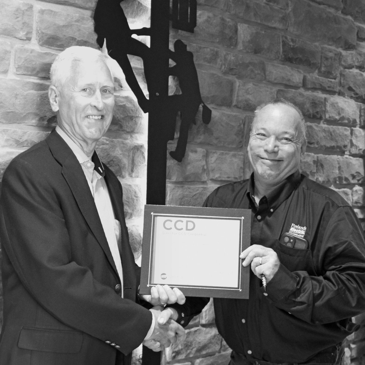 Firelands's tweet photo. Firelands Electric's Board Pres. and District 1 Trustee Dan Schloemer (left) recently presented District 7 Trustee Greg Hess (right) with his Credentialed Cooperative Director (CCD) certificate from NRECA. Learn more: https://t.co/gJbQthBVGY https://t.co/VObyGplsbc