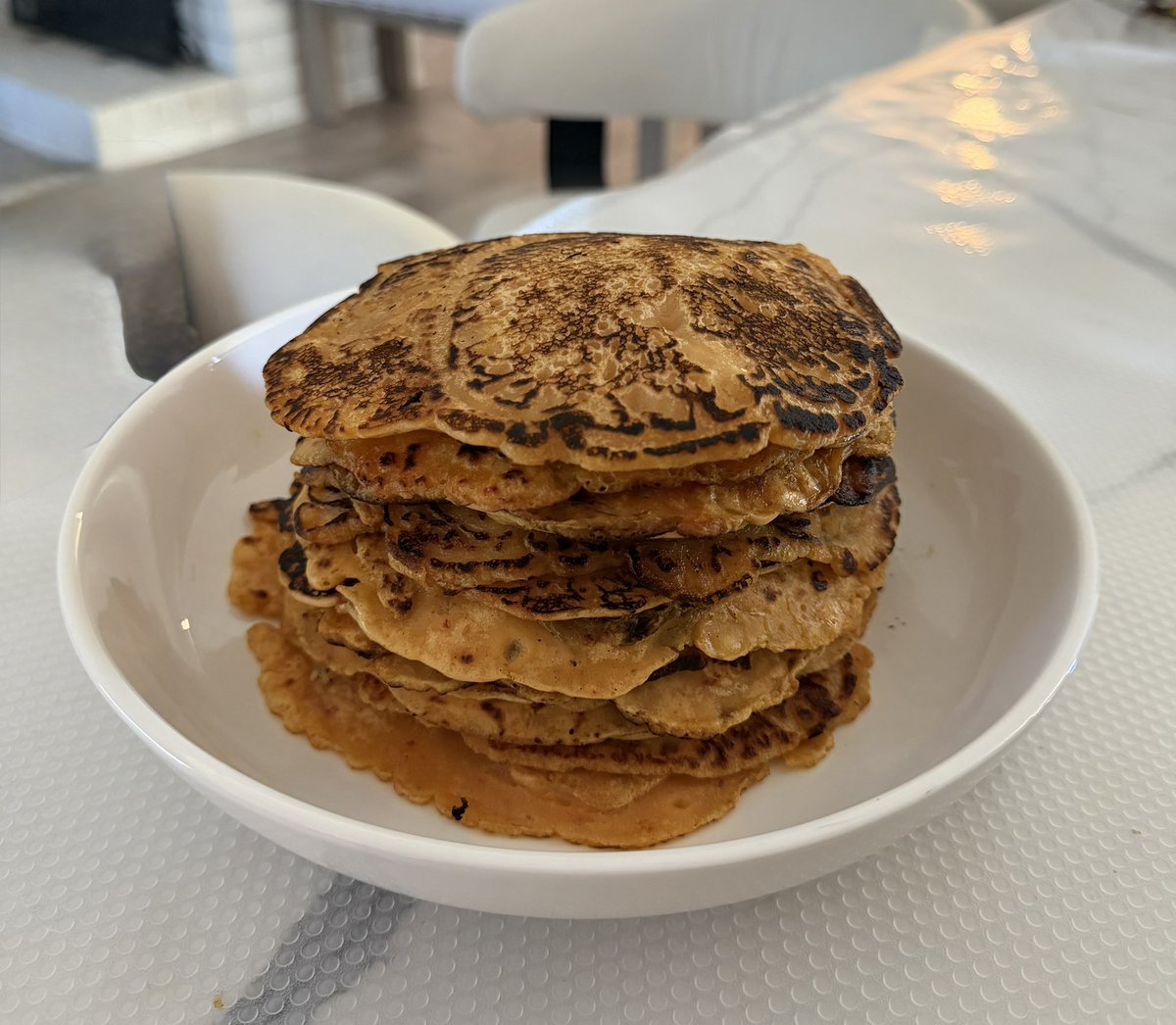 kimchi pancakes that im eating w more kimchi. the smoke detector went off while i was making these😭