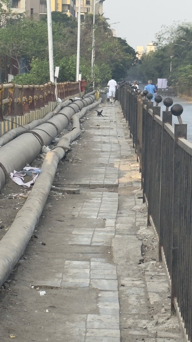 RRanshinge's tweet photo. @mybmc kw ward This footpath has no space to walk and tiles have been completely damaged. This is the bridge where people need to walk on a footpath. See the condition of the pipes can damage or injured someone. Lokhandwala Millta Nagar Bridge. https://t.co/ge4NUGEjHV