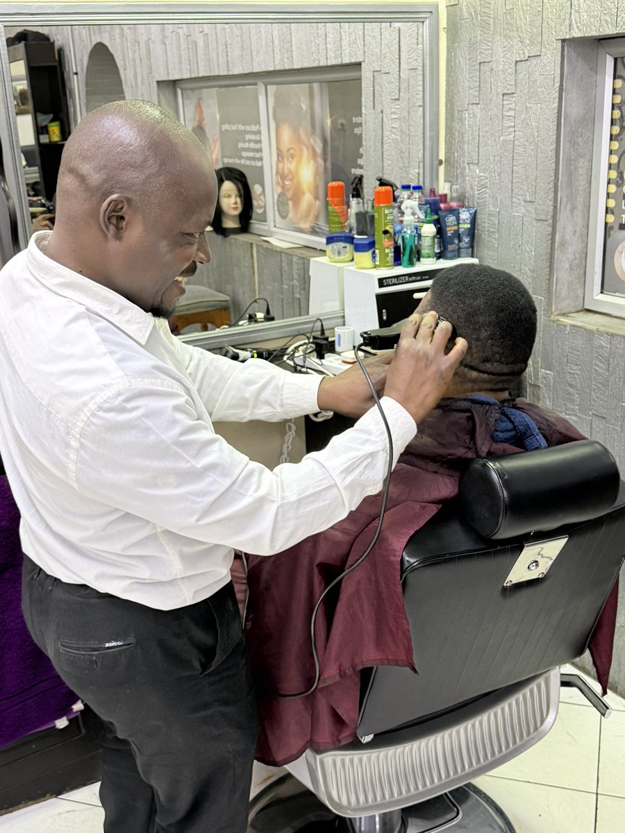 waltermzembi's tweet photo. My Barber since the turn of the new millennium Eddie , of Shave Centre is back at work after an 8 year break !  He says  it will take three or four correctional hair cuts to restore the legendary “Mzembi Cut” . I recommend him , he is good ! https://t.co/ZOEjYX5lW1