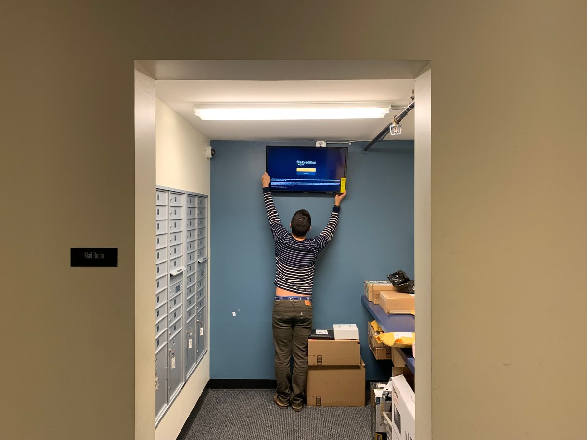 ChrisDukich's tweet photo. 2019: I mount a TV in my condo building's mailroom. 
$200 Toshiba from Best Buy. Energy Guide sticker still on.

2025: Same screen, still running. Property manager updates it 
from a Google Sheet on her phone.

6 years. 1,200+ customers. 180+ countries.

The whole company started from this mailroom.