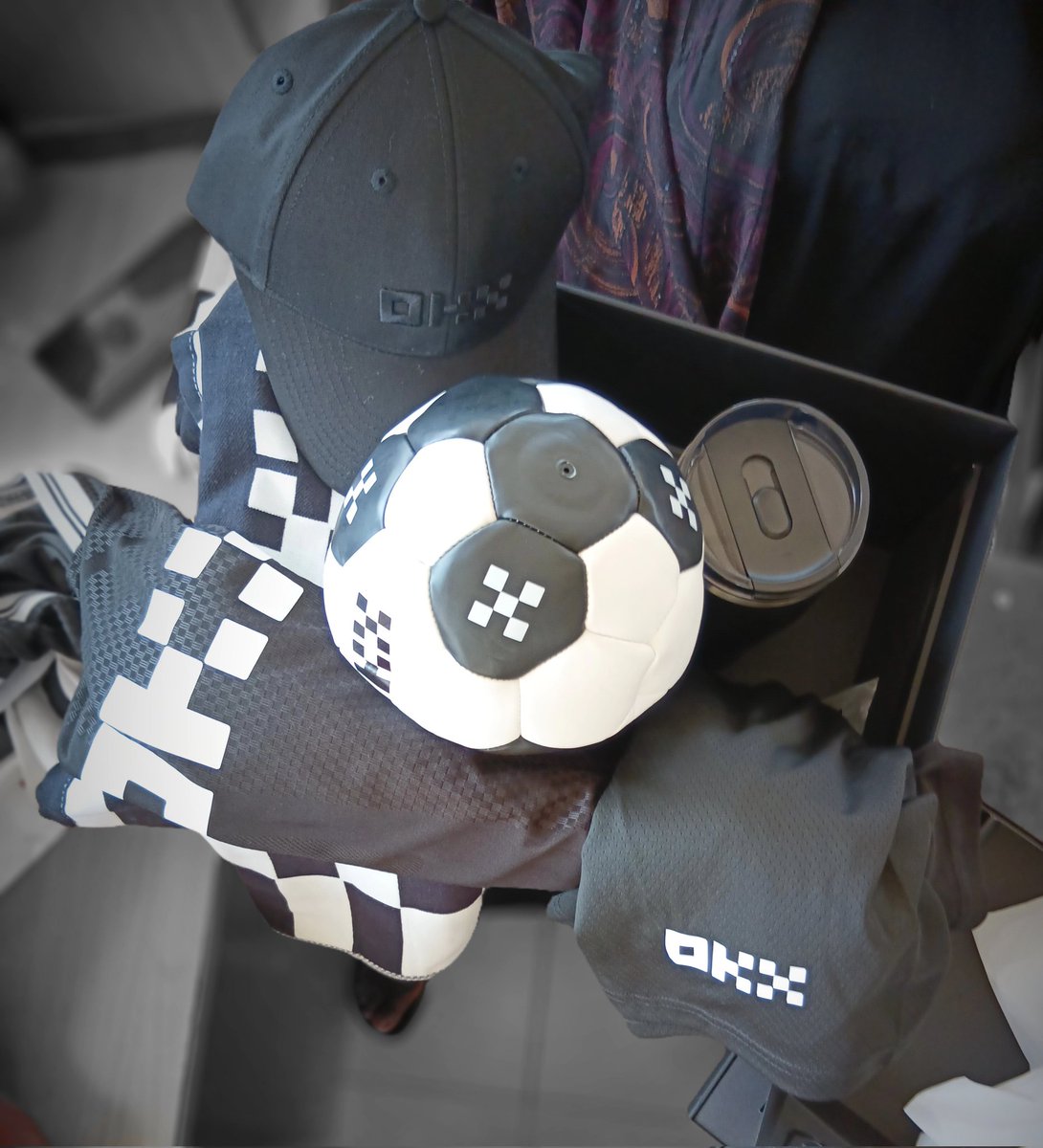 Johw_vinchy's tweet photo. Grateful doesn't even cover it 🙏 The @OKX merch package just landed and honestly? It's a whole vibe 🖤⚽🧢

Mini football, jersey, cap, Stanley cup all blacked out, all clean, all intentional. The attention to detail is on another level entirely. https://t.co/nBQ5LoZQoC
