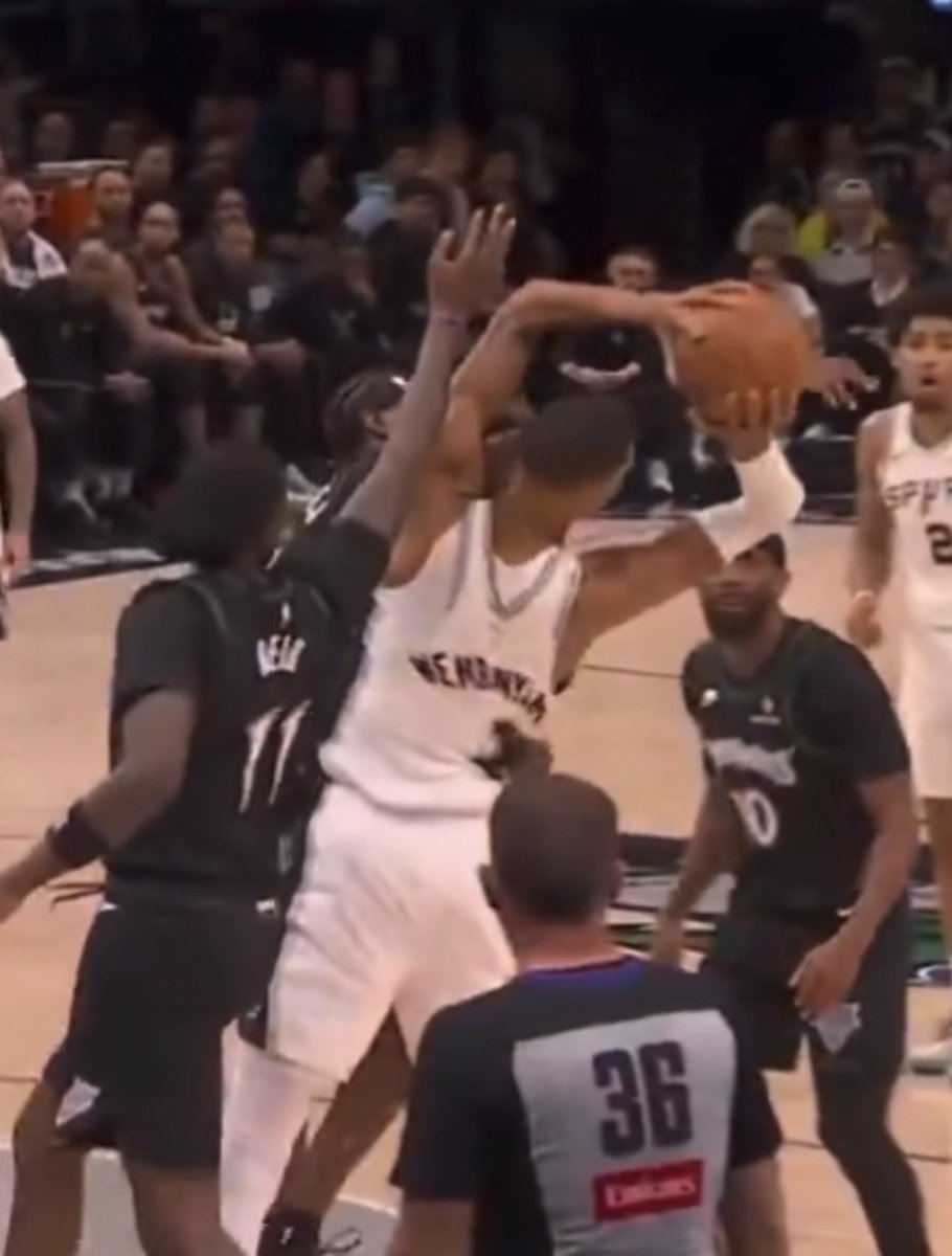 AyeSiwmae's tweet photo. @SpursReporter Naz holding Wemby’s leg before the rebound. McDaniels has got is arm wrapped around Wemby’s waist and hit Wemby in the face unintentionally. https://t.co/4FCU4nWeHi