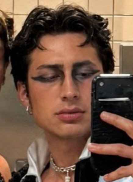 tollmetron's tweet photo. everyone is saying he looks so good but to me the jaw looks kinda ridiculous in a gigachad way + ai gave him lip fillers too. the original is not good enough quality to get this when zooming in. especially comparing to his face in other photos i think it's clear. the eyeliner too https://t.co/11MDjvjSVR