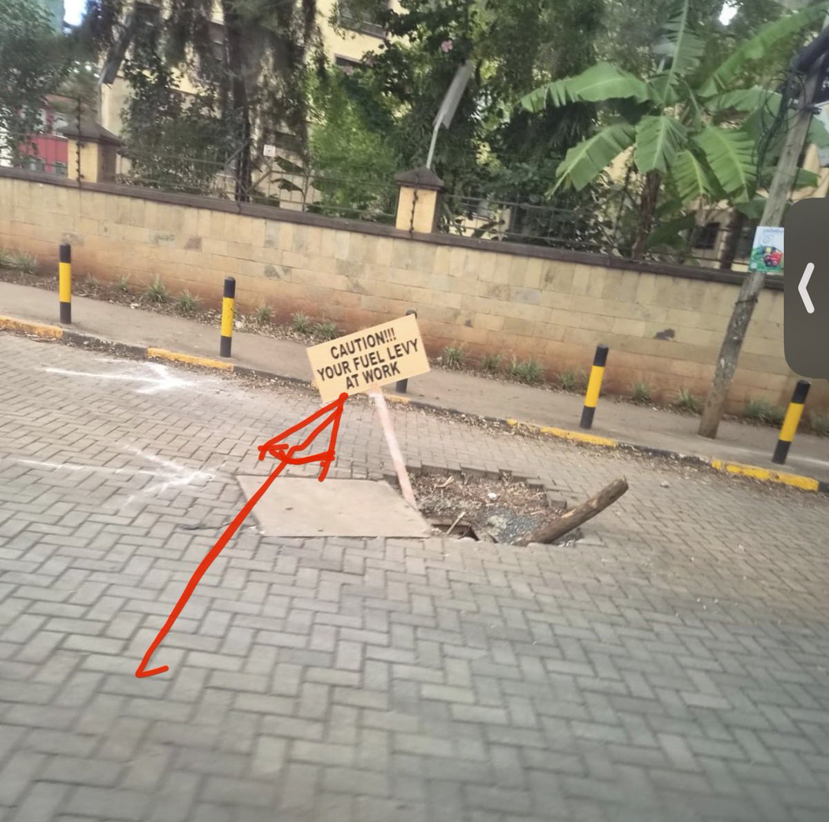 smutoro's tweet photo. A gaping hole in the pavement. A makeshift sign planted in it reading: “CAUTION!!! YOUR FUEL LEVY AT WORK.”
🫆They are not even ashamed. This is the work. A sign is the repair.
🫆Kenyans pay a whopping Sh25/litre in fuel levy. Roads look like this. Someone  is “eating” very well! https://t.co/RmCsWKxG2f