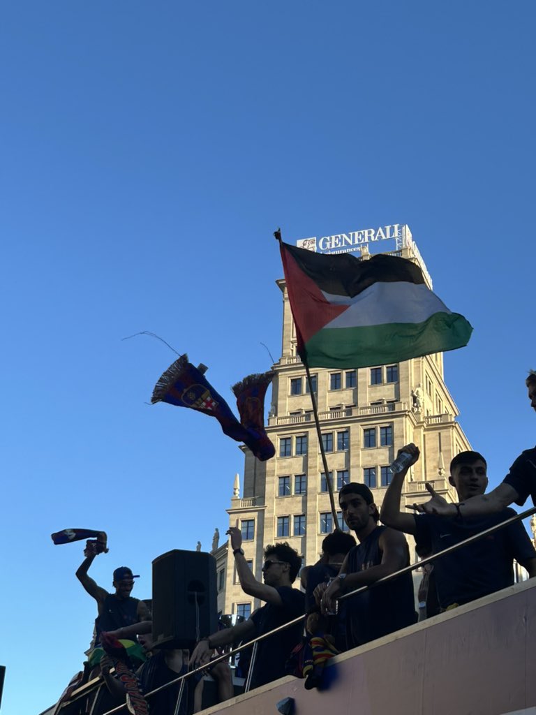 Lamine Yamal waving a Palestinian flag during the street parade.