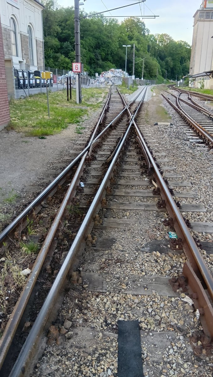 Tavata_Narrow's tweet photo. おまけ
隣駅のSt. Pölten Alpenbf構内を通過中、標準軌の線路が自分の列車の床下に吸い込まれていくのを見て「もしかして3線軌か？」と気になって下車後に見に行ってみました。
実際は3線軌ではなく、標準軌の引込線と狭軌(760mm)のクロスでした！
見た目だと倍半分に見えます。 https://t.co/UgFAQxjti5