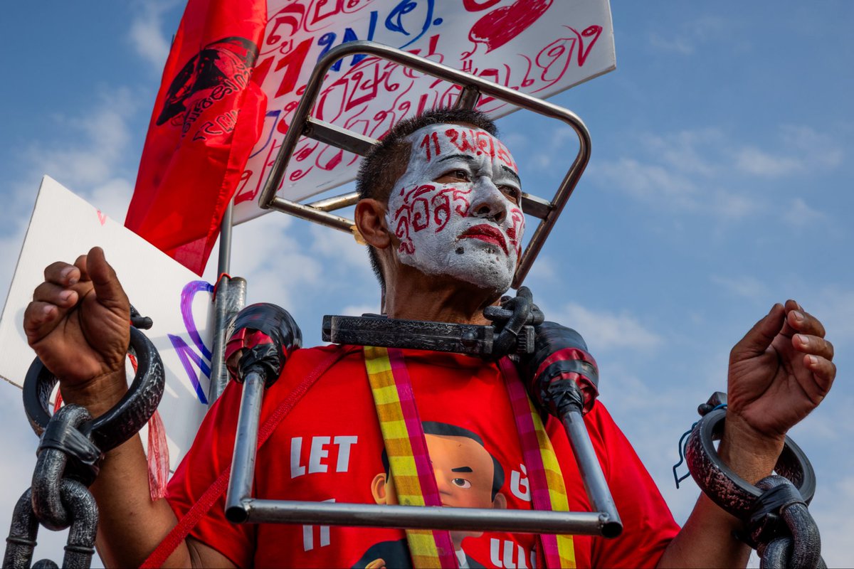 HooverLinnea's tweet photo. A Red Shirt supporter with his face painted white and the words “คนอีสาน” (“Isaan people”) written in red across his face waits outside the Klong Prem Central Prison on May 11, 2026, as crowds gathered for the release of former Thai Prime Minister Thaksin Shinawatra.
Thaksin returned to Thailand in 2025 after more than 15 years in self-imposed exile and was immediately taken into custody to serve prison sentences related to corruption and abuse-of-power convictions. 
Supports showed up on mass, hoping for a glimpse of the former Prime Minster, despite his conviction, self-exile and imprisonment — and loyalty continues to run deep. One support told me that he should never have been imprisoned in the first place.
.
.
.
#shotoncanon #natgeoyourshot #nppa @CanonUSA @NatGeoPhotos @NPPA @womenphotograph