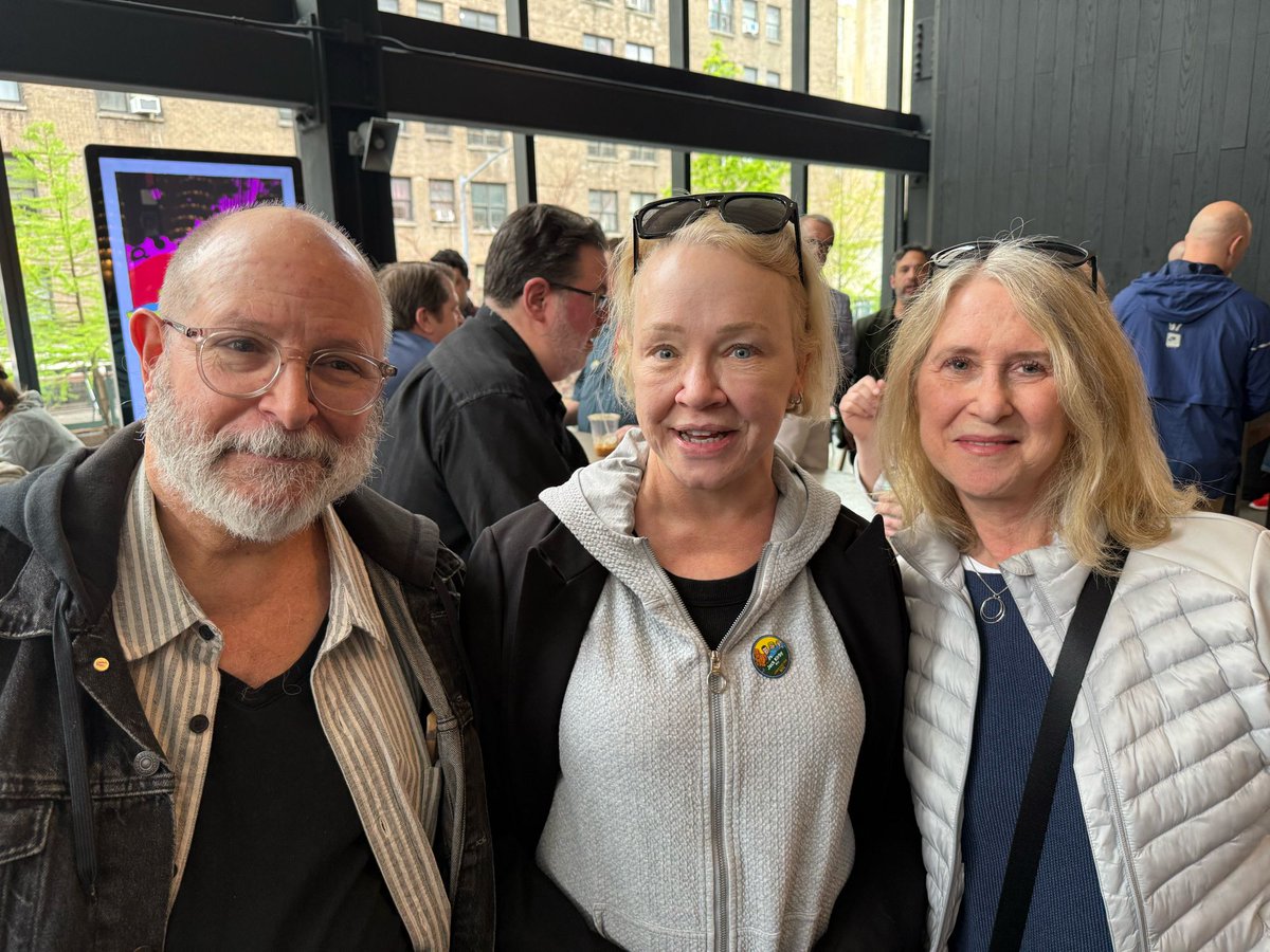 PWComicsWorld's tweet photo. At the Essex Market reception: acclaimed comics artist Mike Mignola, wife Christine, and legendary comics editor Karen Berger just before the unveiling of Jack Kirby Way at the corner of Delancey &amp; Essex streets on the LES. Photo: C.Reid https://t.co/TAe3RW4Wd0