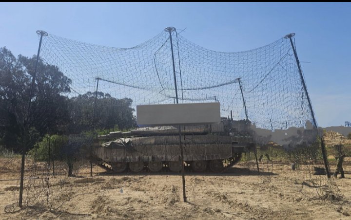 MarioNawfal's tweet photo. 🇮🇱🇱🇧 Israel has the Iron Dome. F-35s. The Trophy system, designed specifically to protect tanks from incoming threats. Billions in defense tech, decades of military innovation.

Hezbollah's answer: a fibreglass drone. Immune to jamming. Bypasses Trophy. 

Israel's counter, right now: fishing nets over parked vehicles.

Netanyahu says a real solution "will take time."