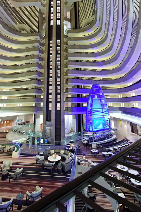 SinineTheYote's tweet photo. @RuneyBoiAD @KyTyger It’s the inside of the Marriott Marquis at FWA. People climb on the bars to take pictures. The painting is of someone falling, which hasn’t happened at con yet https://t.co/Cj6xecfm1t