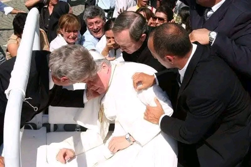 UcheMaryOkoli's tweet photo. The Pope of Our Lady of Fatima

On May 13, 1981, in St. Peter's Square, exactly 64 years after the first apparition of the Virgin Mary to the three shepherd children in Fatima, Portugal; Turkish gunman Mehmet Ali Agca took aim at the Pope with a handgun (circled at left, above). 

Four bullets hit John Paul II, two of them lodging in his lower intestine, the others hitting his left hand and right arm.The bullet missed his central aorta by a few millimetres — had it not missed this, the Holy Father would have been killed instantly. The Pope, who lost nearly three-quarters of his blood and suffered shock from blood loss, underwent five hours of emergency intestinal surgery at the hospital.

While he was in the hospital, Pope John Paul reviewed the Church’s documentation of Fatima and the Third Secret of Fatima. He was convinced that Our Lady of Fatima had saved his life. Later that year, he had a mosaic of the Virgin Mary (Mater Ecclesiae — Mother of the Church) installed on St. Peter’s Square. He went three times afterwards to the shrine of Fatima in Portugal (1982, 1991 and 2000) — to thank the Virgin Mary. 

On March 25, 1984, to fulfill the request of Our Lady of Fatima, the Pope consecrated the world — including Russia — to the Immaculate Heart of Mary and Communism collapsed soon afterward.

On Dec. 27, 1983, when Pope John Paul II visited Mehmet Ali Agca, his would-be killer in jail, the man asked him: “Why didn’t you die? I know that my aim was true and I know that the bullet was very powerful and mortal.” The Pope responded: "One hand fired the shot. Another (the hand of the Virgin Mary) guided it.”

As a measure of his gratitude, John Paul gave the bullet that was extracted from his abdomen to the shrine; the bullet today forms part of the crown of the statue of the Virgin of Fatima. 

During John Paul's 2000 visit to Fatima, the third part of the message the Virgin gave to the three children in 1917 was revealed; it was a description of the assassination attempt on Pope John Paul: the “bishop clothed in white” who prays for all the faithful is the Pope. 

As he makes his way with great effort towards the Cross amid the corpses of those who were martyred (bishops, priests, men and women religious and many lay persons), he too falls to the ground, apparently dead, under a burst of gunfire.
- The Source of Miracle- Divine Mercy Miracles.