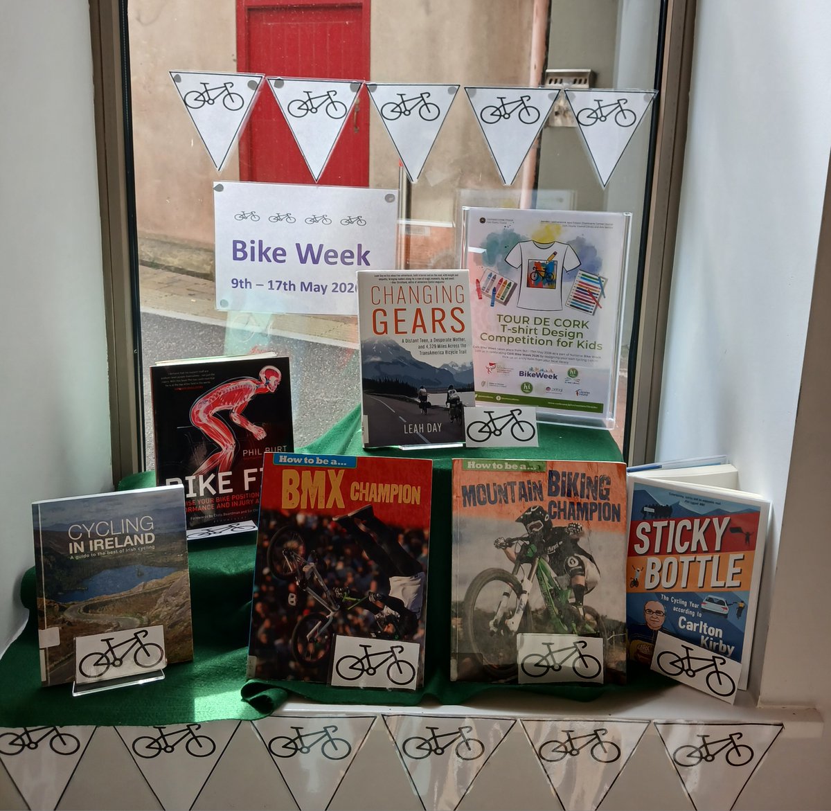 corkcolibrary's tweet photo. 🚴Don't forget about our Bike Week 2026 T‑Shirt Design Competition for Kids!
Join us in celebrating Cork Bike Week by designing your very own cycling‑themed T‑shirt!📝 Entry forms are available from your local library, so pop in and pick one up.

📸 Take a look at some of the fantastic Bike Week displays from libraries across Cork County – we love seeing how each branch is celebrating!

 @Corkcoco @CorkSports @HealthyIreland  #BikeWeek2026 #CorkBikeWeek2026 #CorkSportsPartnership #CobhLibrary #MacroomLibrary #CarrigalineLibrary