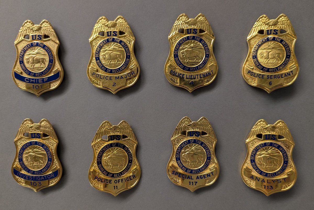 InteriorMuseum's tweet photo. We’re sharing more of the museum’s law enforcement artifacts in honor of National Police Week: From 1931 through 2017, the Hoover Dam Police Department protected the dam ecosystem that straddles the Arizona-Nevada border. Today, National Park Service law enforcement rangers provide area security, and a separate Bureau of Reclamation Security Response Force stationed at Hoover Dam itself ensures the uninterrupted delivery of water and hydropower. 
📷 Eight badges from the former Bureau of Reclamation Hoover Dam Police Department, INTR 07932 – INTR 07939.