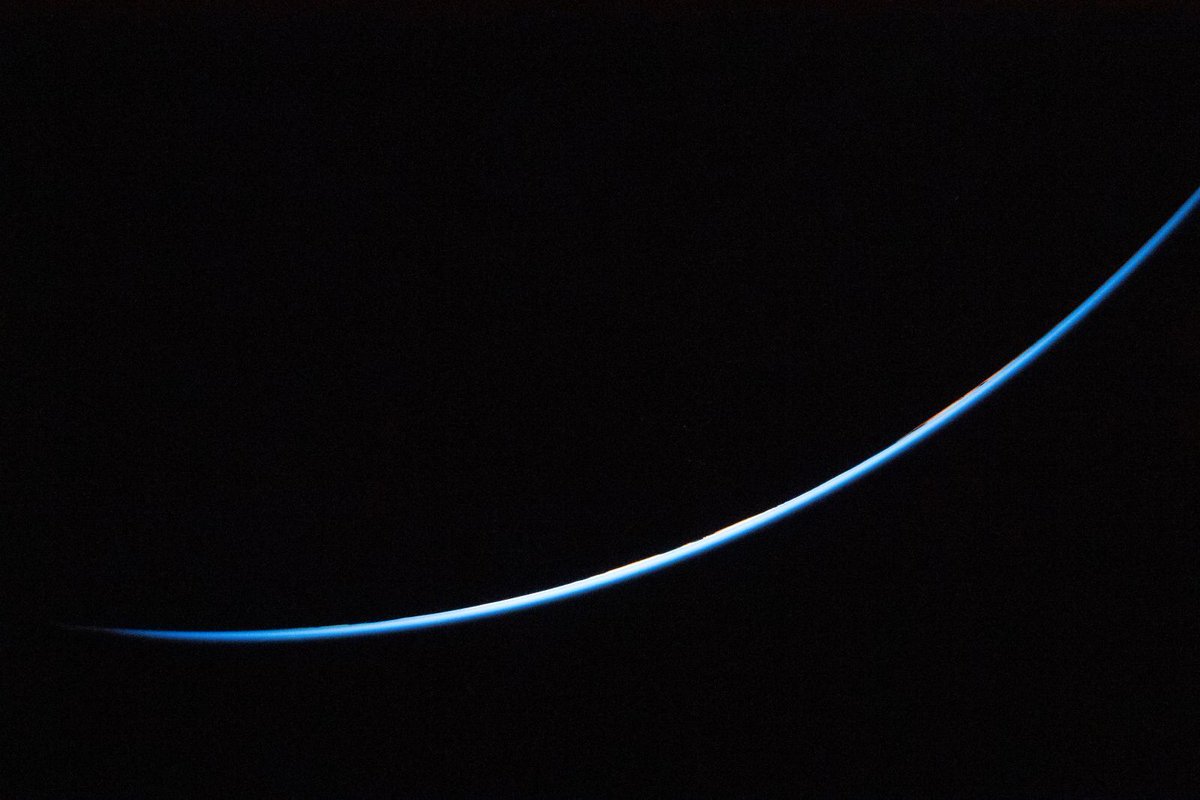 SETIInstitute's tweet photo. #PPOD: A Light in the Dark 🌃 

A thin sliver of Earth’s edge is brightly illuminated against the vast darkness of space in this April 3, 2026, image taken during the #ArtemisII mission. This thin blue ribbon is what separates us from the abyss of space vacuum: the Earth's atmosphere.

Credit: @NASA

#planetaryscience