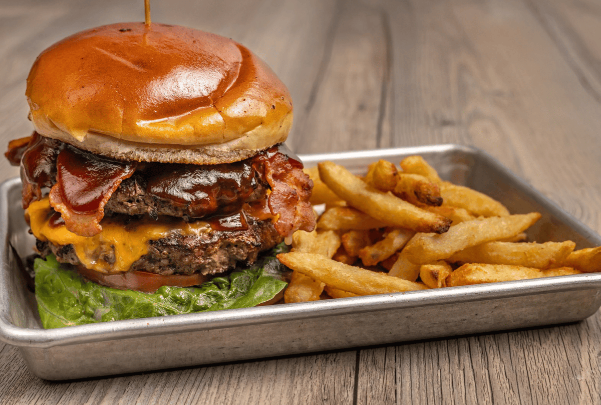 Tables_Taps's tweet photo. BBQ Bacon is the one everyone keeps coming back for 🔥 Stacked with BBQ sauce, hardwood smoked bacon, American cheese, fried onion, lettuce, tomato, and a brioche bun—it's easy to see why it's a favorite at Tables and Taps. #BBQBacon #TablesAndTaps #BurgerLove https://t.co/pXCjpSWB2o