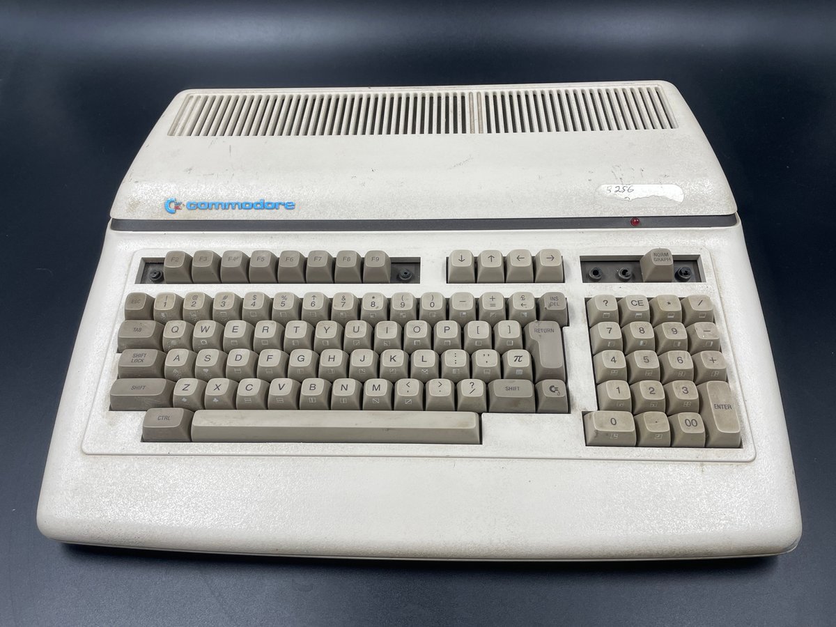 commodoreihs's tweet photo. I snagged this Commodore 620 off eBay recently because it was an interesting piece. First, I have to thank my friend Steve Gray for providing background information to me on CBM-II model numbers, because I manage to screw them up every time. The Commodore 620 was the European market version of the North American B256. It's the low profile CBM-II model with 256K RAM. This one, despite being the European model 620, seems to have been modified for the North American market, as the PSU was converted to 117VAC. You can see on the serial sticker that there's a 117V sticker on top of the original serial sticker. Given that it's the same color and style, I'm guessing Commodore modified this, not a consumer. It's serial 00031, which is a low serial, but the chip  date codes range from 2182 to 2983 (May 1982 - July 1983). It's in generally working condition, and it boots to the native boot  screen saying, "commodore basic 256, v4.2". I have a line on a  replacement keyboard, so the missing keys won't be a problem.
