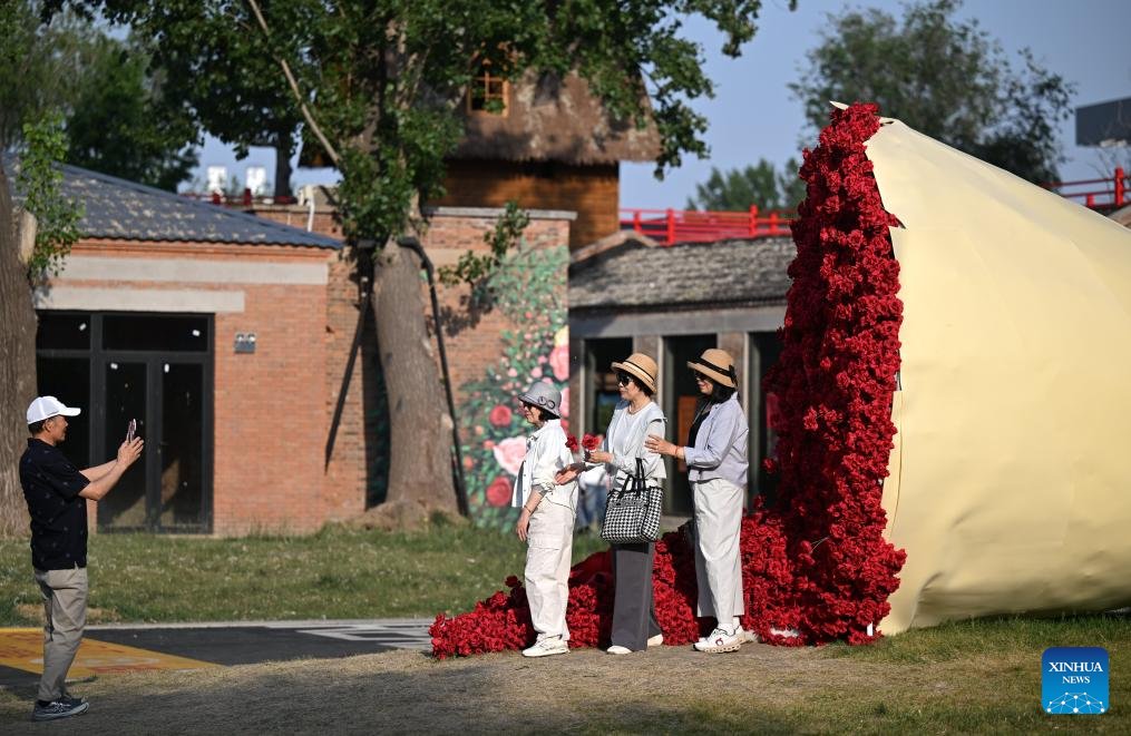 AboutChina_'s tweet photo. Tourists pose for photos at a tourism and leisure block in Zhongbei Town of Xiqing District in China's Tianjin, May 12, 2026. (Xinhua/Li Ran) https://t.co/47GGvlzGmU