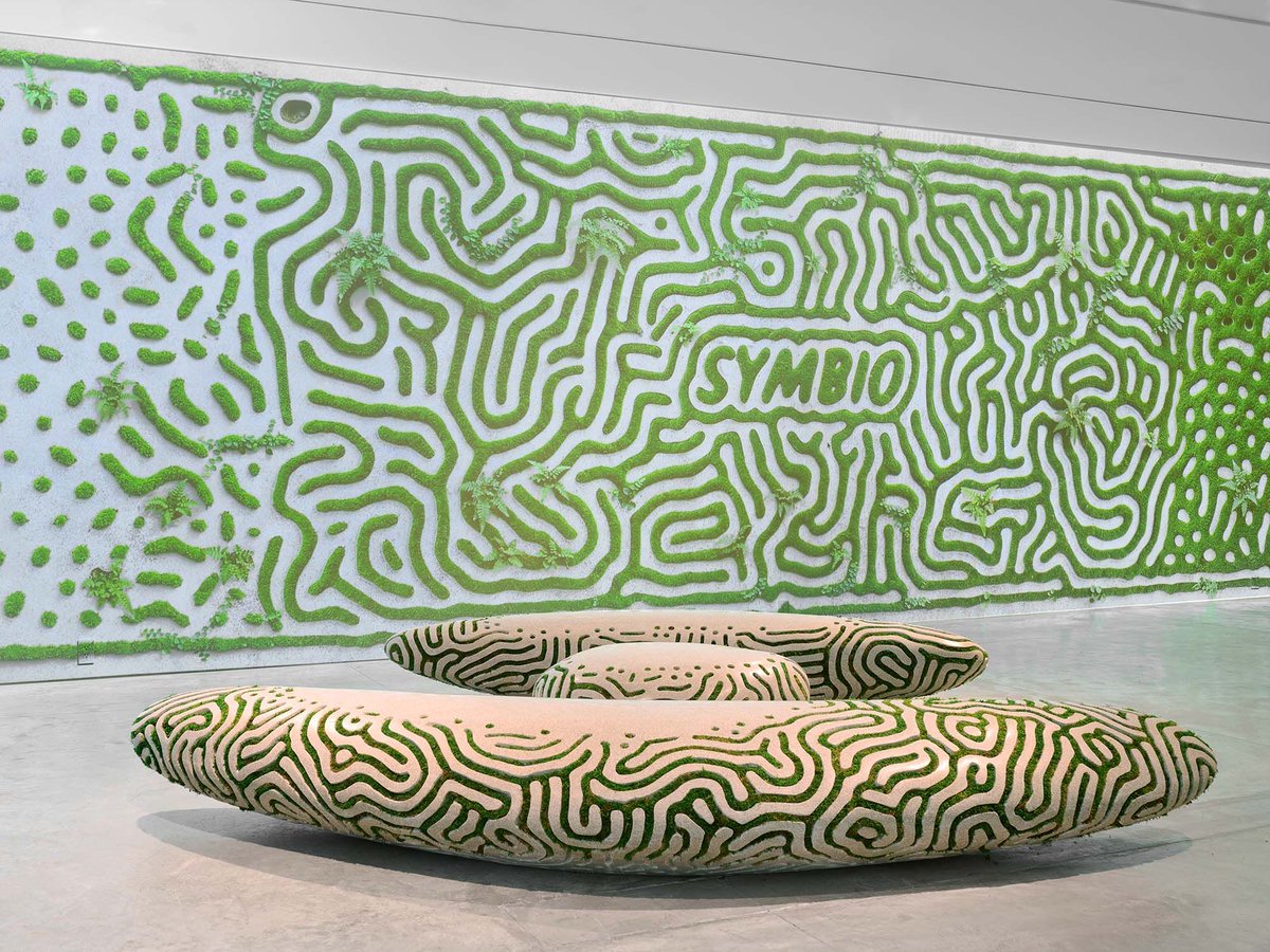 Behold3d's tweet photo. Joris Laarman’s Symbio Benches (2026) at Friedman Benda, NYC — massive 3D-printed recycled/carbon-capturing concrete forms with Turing-inspired reaction-diffusion channels embedded with bio-active substrate for living moss & lichen growth. Boulder-like scale meets symbiotic living textures that evolve over time—pure regenerative sculpture/installation hybrid pushing additive + biology! 🌿🪨✨  

 https://t.co/TZnFU1evS6