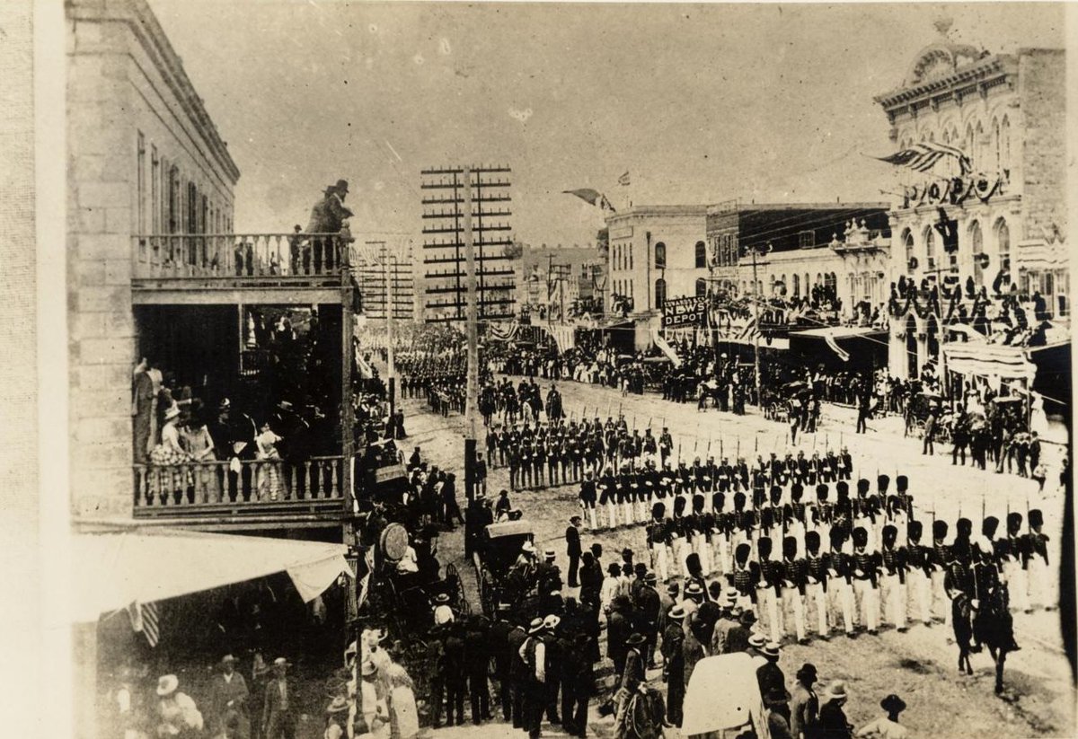 WalkerATX's tweet photo. Today in Austin History:
Week-long Capitol Dedication Begins
AUSTIN, TX May 14, 1888 (@fox7austin) — 138 years ago today...
Crowds packed the sidewalks and second-floor balconies along Congress Avenue to watch the start of the week-long Texas Capitol dedication. This photo from the Austin History Center shows a military parade featuring troops and drill teams from several different states marching toward the new building. Spectators arrived in their best formal attire, with women in gowns and men in suits lining the route to witness the processional.
The parade kicked off a series of events that brought thousands of visitors to Austin from across the country. Although the Capitol was already finished, this 1888 celebration marked the formal acceptance of the granite structure. The military units remained a primary draw throughout the week, participating in precision drill competitions and ceremonies on the Capitol grounds.
The week in Austin featured a variety of public events throughout the city. The schedule included nightly fireworks displays, choral concerts and a grand dedication ball. Local businesses and temporary vendors hosted visitors arriving by excursion trains, while the formal ceremonies culminated with keynote speeches delivered from the Capitol portico to officially turn the building over to the state. #txlege