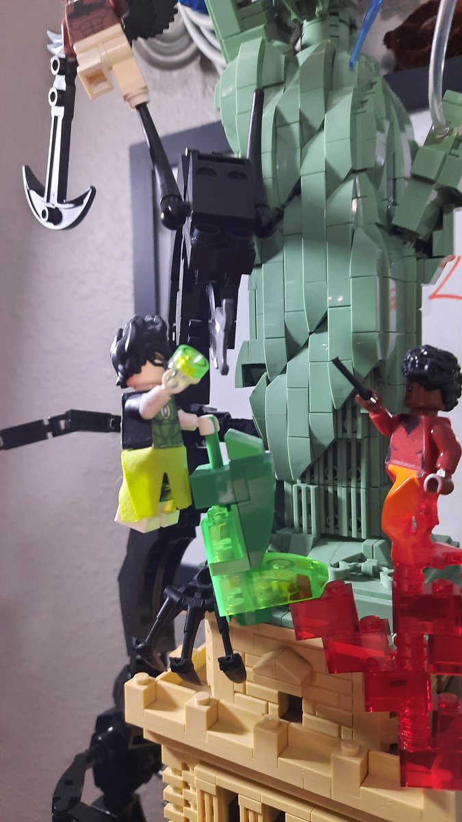 Sydpart2's tweet photo. Decided to move the Bombshells MOC but the new shelf was too small to fit the old dragon on it. So I decided to beef it up a bit and rework the Statue of Liberty build so it can just connect in with some technic bricks. Pretty happy with how everything turned out. https://t.co/S59GdyN9AM