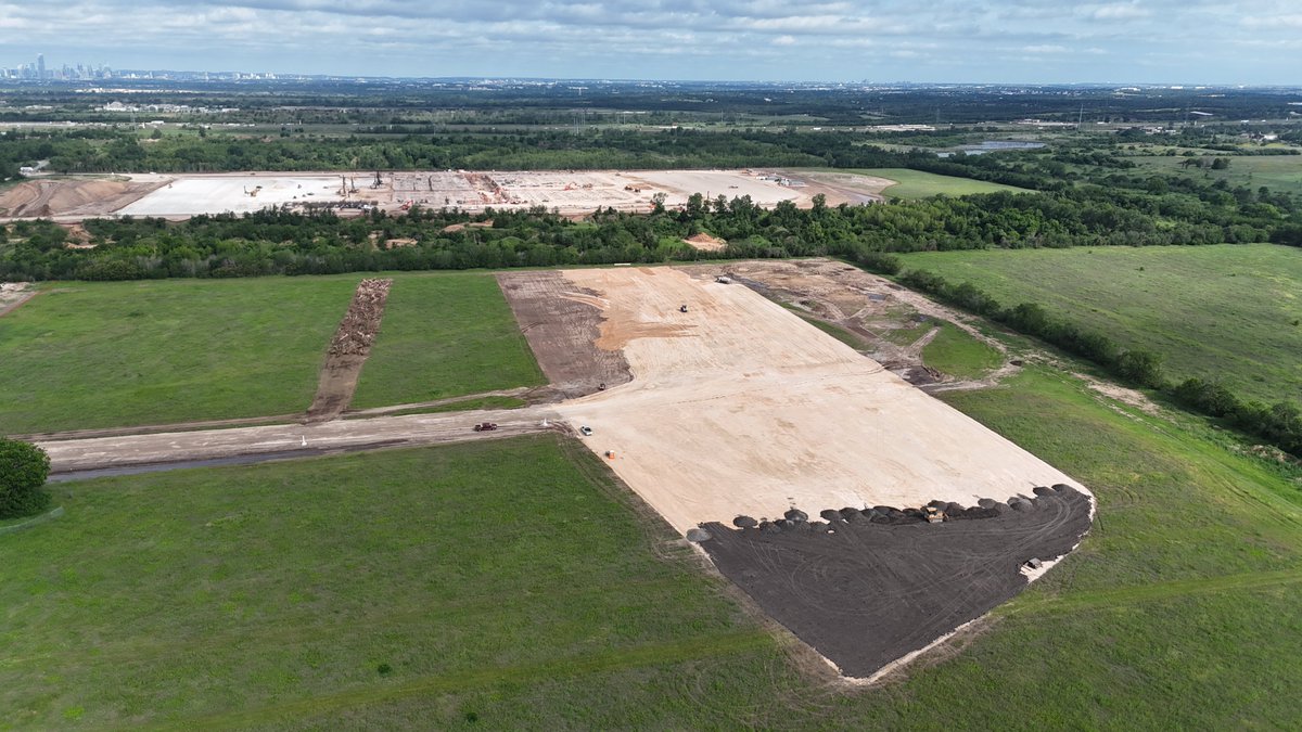 JoeTegtmeyer's tweet photo. The new Giga Texas Optimus factory foundation work continues with three distinct sections under construction. 

On the south end of what I think may be phase 1 of the construction, the large depressed graded area has had about .5 to 1 meters of gravel and crushed concrete added and now GeoPier equipment is at work. 

On the middle section, dense footings of two primary types are being constructed, suggesting heave loading of the structure in this area. 

On the north end, it’s mainly flat grade with little footing work so far. 

I say I *think* this might be a two phase construction project because the north perimeter grade beam is laid out as if it is the final configuration, but the south end is not. There is a large field south of this area that, with reclamation work, could support a doubling of the structure, if that was desired.