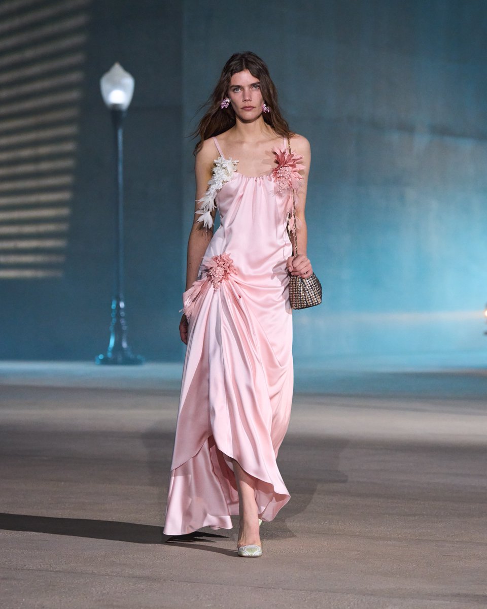 Dior's tweet photo. Dior Cruise 2027.

Look 5: Icy pink satin caught at the hip with a handmade flower, a lustrousness echoed in an embroidered houndstooth bag.

https://t.co/jzfu3q6DGq

#DiorCruise https://t.co/zBXN159uU1