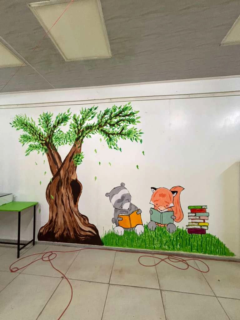 peacecorpguyana's tweet photo. #PeaceCorps Volunteer Caroline teamed up with colleague Avery to create a child-friendly mural filled with imagination and warmth to update her school’s library! 📚📚📖We love the creativity. #PeaceCorpsGuyana #Service #MakingLearningFun 🇬🇾 https://t.co/XTi9OhsrGf