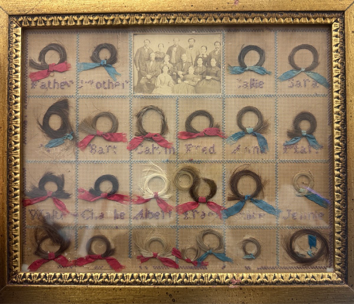 LuxMentis's tweet photo. Today’s find: Victorian hair collection circa 1850…post-mortem photo at top.  23 locks, red for bois, blue for grrrls. Most crossstitch legible. Day made. https://t.co/15PVwxQf4x