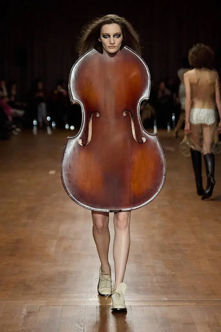 IntDesignDiva's tweet photo. Concerto Couture - Hodakova's runway show features a stringless violoncello worn as a dress so no fiddling around! #FashionistaFri https://t.co/rmmvXakA2i
