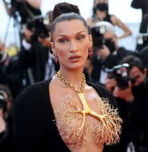 lesbeyonsay's tweet photo. that pandemic woke era was so strict bc why did bella hadid get dragged for wearing a dress that looks like lungs at Cannes? 😭 https://t.co/Qv1rwbnyHJ