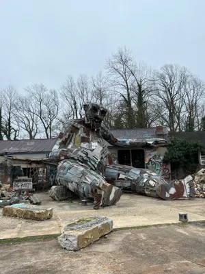 Veewyd's tweet photo. Big Rusty
A giant scrap metal troll rests his hands on top of a dilapidated building covered in graffiti.

Big Rusty is a metal, cement, and wooden troll created by Danish artist Thomas Dambo. 

https://t.co/Tzl2CUZuMJ https://t.co/UOW6eqaifN