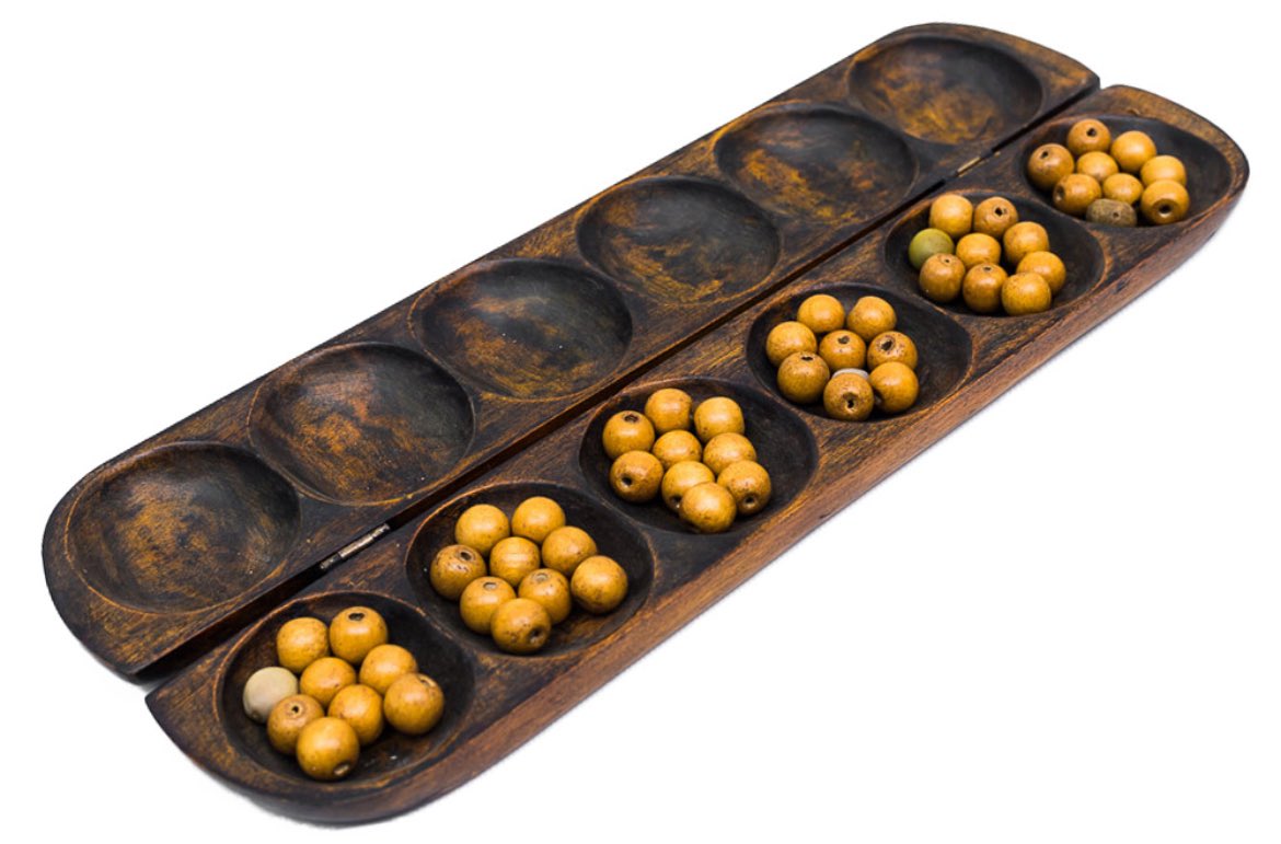 Zamani_WLK's tweet photo. Ayo Olopon is a Yoruba strategy board game played on a wooden board with 12 holes and 48 seeds. Every move requires calculating your opponent’s next three moves. Children in Yoruba households were developing mathematical and strategic thinking through play. No classroom required. https://t.co/mFfZJQmfPK