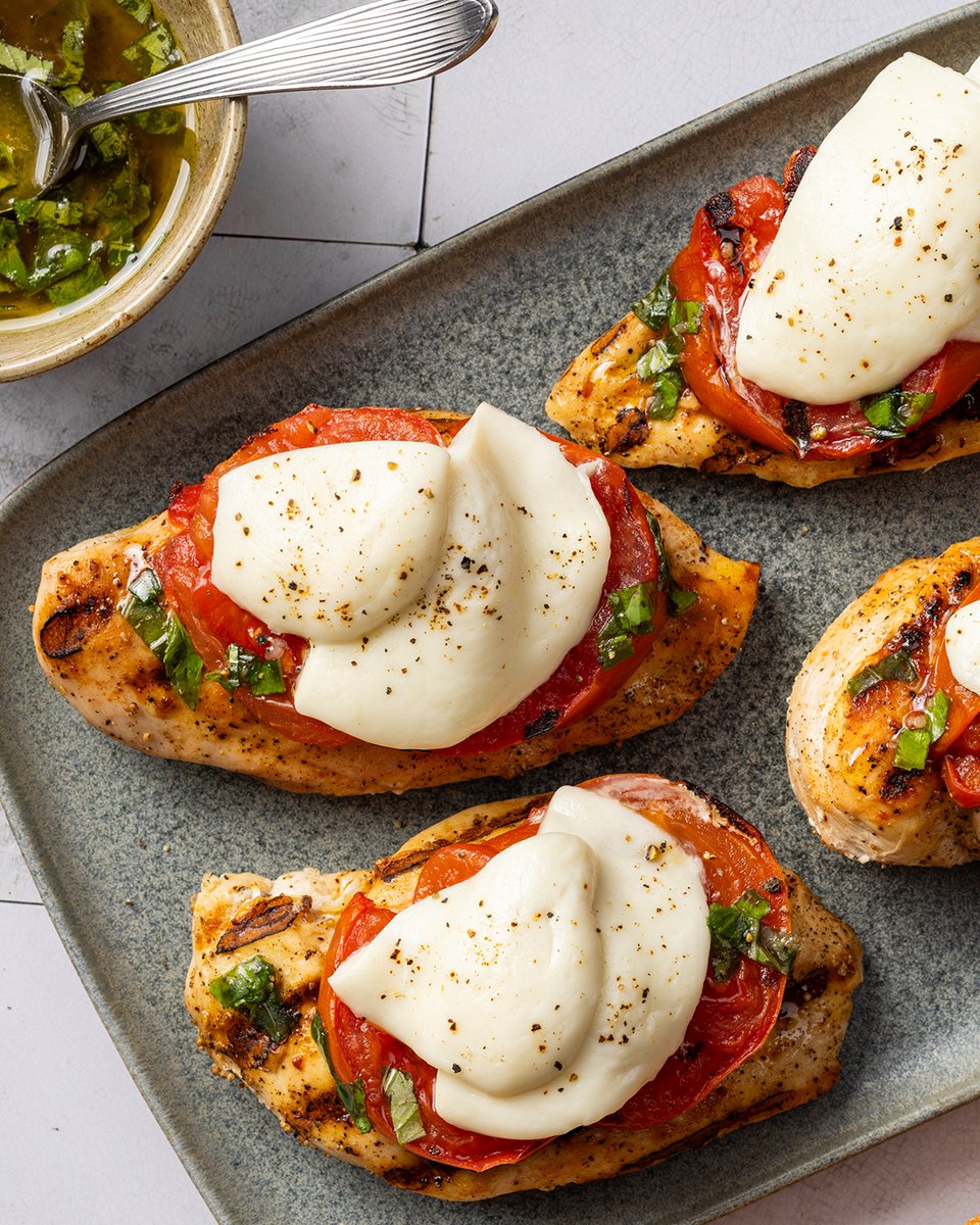 TestKitchen's tweet photo. Caprese meets the grill: Tomatoes, mozzarella, basil vinaigrette, and grilled chicken cutlets, a summer classic, elevated. https://t.co/SlolBE3l6e https://t.co/YaRfKuYDUC