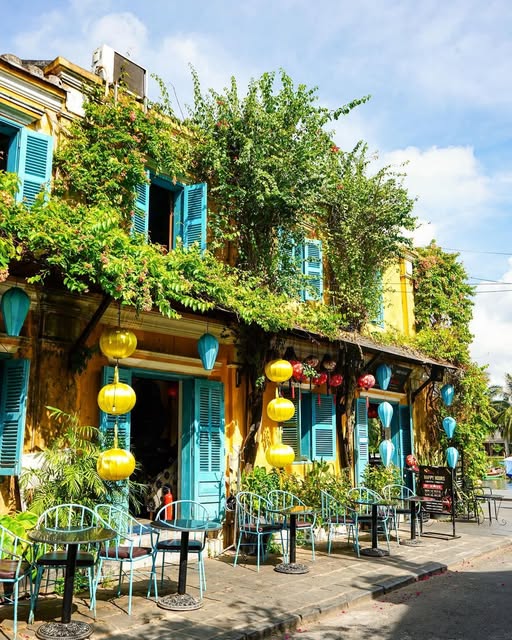 LocDang4's tweet photo. The moment you look at this photo, it feels as if time slows down. The warm golden walls, turquoise-blue shutters, and colorful hanging lanterns create a dreamy atmosphere that blends nostalgia with tropical elegance. https://t.co/BdyL8OSfoN https://t.co/9pkrg5DHOe