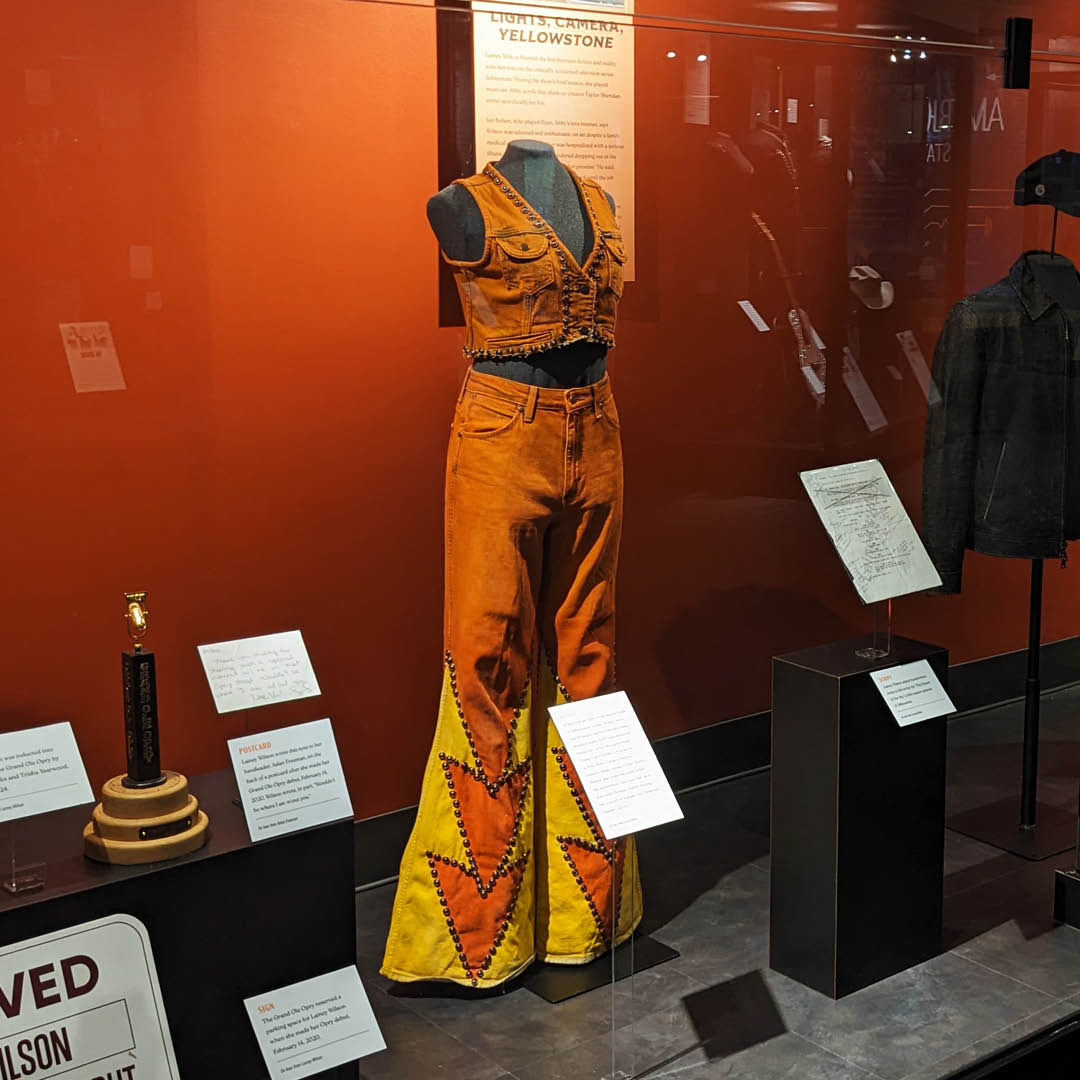 countrymusichof's tweet photo. @LaineyWilson wore this Wrangler denim vest and these studded jeans, both customized by Raina Gir, when she performed "Hang Tight Honey" in her role as Abby in the series finale of "Yellowstone" in 2024, but her relationship with the show began years earlier.

Learn more when you visit “Lainey Wilson: Tough as Nails,” open now through June 2026.