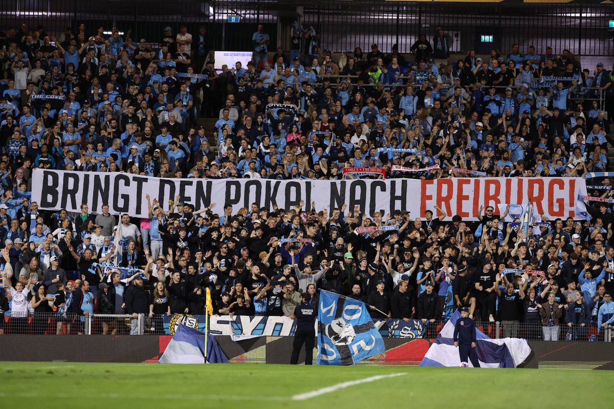 SydneyFC's tweet photo. Best of luck to @scfreiburg in tomorrow morning's UEFA Europa League Final against Aston Villa 🤝

The Cove displayed a good luck message to Freiburg on Saturday night ahead of our Semi Final which translated to "Bring The Cup to Freiburg"

This continues a long standing friendship between The Cove and Freiburg supporters which dates back to 2010 📢

#WeAreSydney