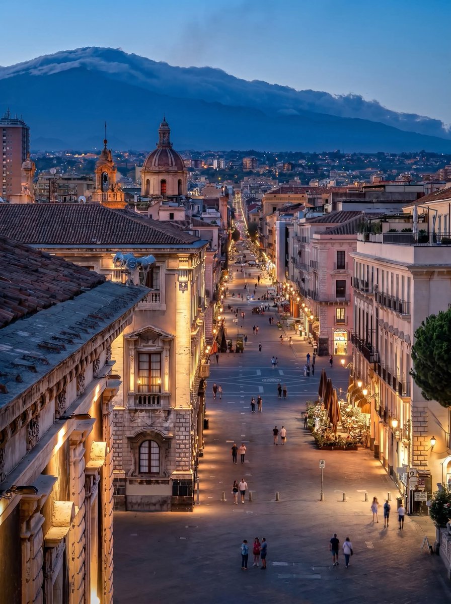 SophiaX_07's tweet photo. *Catania*  
*Italy* 🇮🇹

This is Via Etnea in Catania, Sicily, looking up toward Mount Etna in the background. The Baroque buildings, wide pedestrian street, and the volcano looming over the city are characteristic of Catania. https://t.co/lL8Z4RhR8J