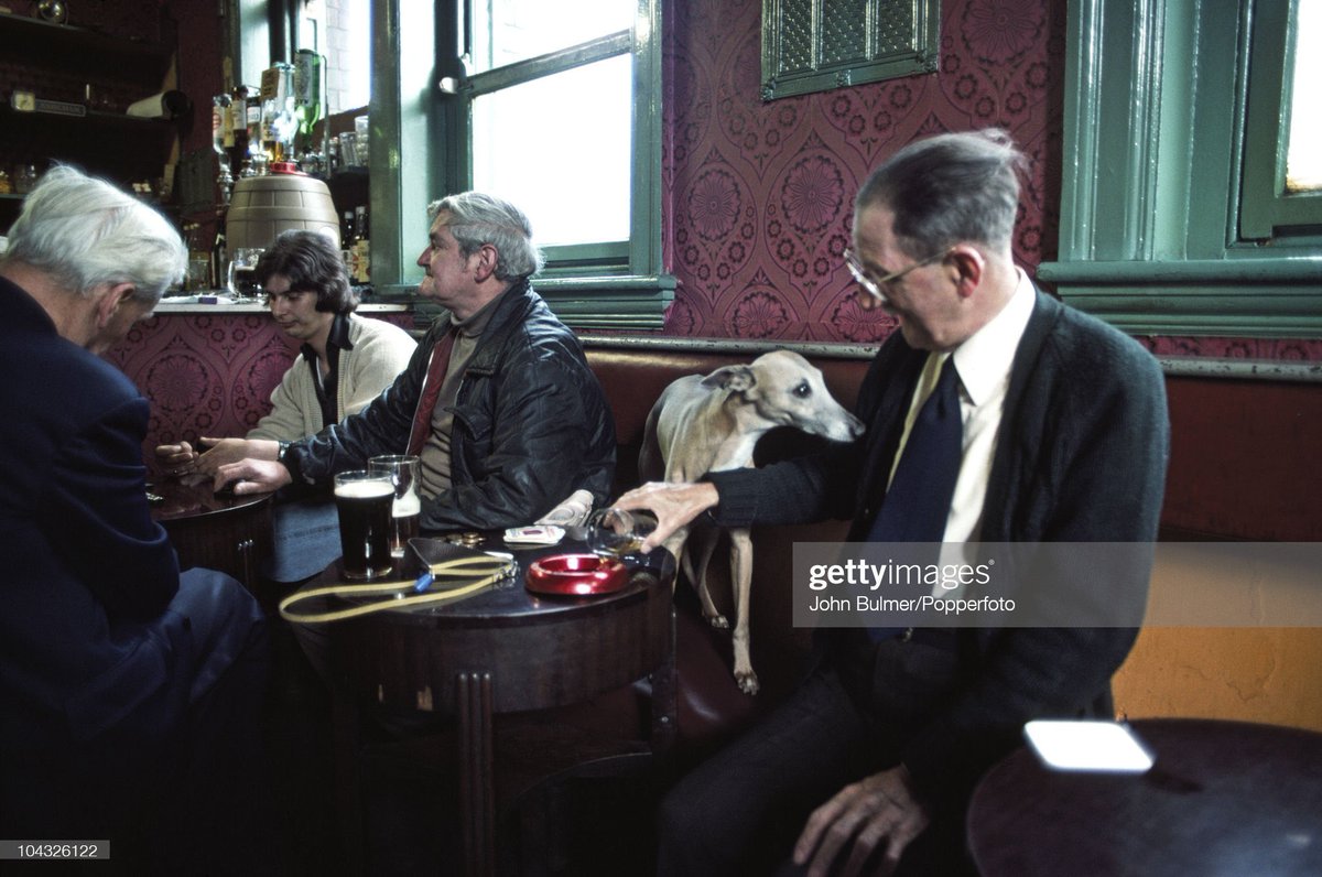 50YearsAgoLive's tweet photo. A man pours a beer into an ashtray for his dog to drink in Manchester, England. https://t.co/lh9I9Od1jg