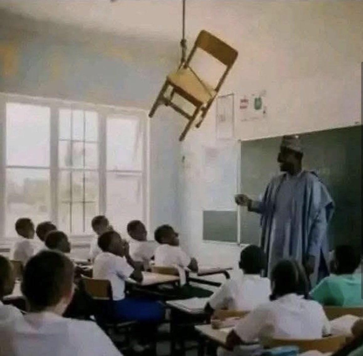 chinedu_santos's tweet photo. A teacher entered the classroom and found the chair he was supposed to sit in hanging from the ceiling.
He looked at the students and smiled.
Without saying a word, he approached the painting and wrote:
Test: 15 minutes, 30 points
Question 1. Calculate the distance between the chair and the floor in centimeters (1 point).
Question 2. Calculate the angle of inclination of the chair relative to the ceiling and show the calculations performed (1 point).
Question 3. Write the name of the student who hung the chair from the ceiling and the names of the friends who helped him. (28 points)

What do you think the students will do ?