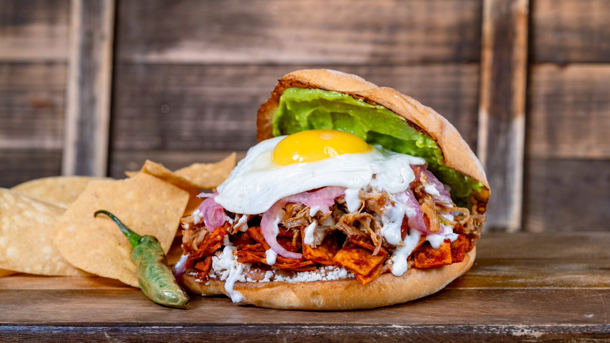 PixieDustFood's tweet photo. DISNEYLAND - HALLOWEEN 2026: Paradise Garden Grill will offer specialty menu items for the season, incl. the Chilaquiles Carnitas Torta w/ red chilaquiles, refried beans, avocado spread, queso fresco, pickled red onions, a fried egg served + chips. #disneyland #disneyhalloween https://t.co/cgeBKuyuvd