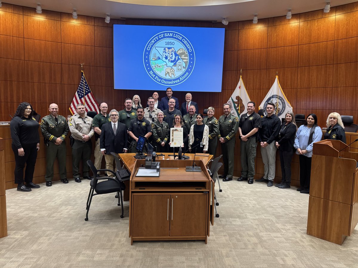 SLOSheriff's tweet photo. This morning, the San Luis Obispo County Board of Supervisors presented two resolutions recognizing the men and women of the Sheriff's Office.

The first recognized National Correctional Officers and Employees Week. While the observance took place in May, we are grateful for the Board's recognition of the dedicated professionals who serve in our Custody Division. Sheriff Ian Parkinson and Captain Stephanie Landgraf spoke about the incredible work that happens behind custody doors every day, often out of the public eye. They highlighted how our County Jail operates much like a small city, caring for individuals with complex medical and mental health needs, providing education and treatment programs, serving more than 1,500 meals each day, and safely managing incarcerated individuals ranging from low-level offenders to violent criminals.

The second resolution recognized National Peace Officers Week and National Peace Officers Memorial Day. Sheriff Parkinson spoke about the daily service and commitment demonstrated by our patrol deputies, detectives, support staff, and peace officers throughout the county. He also reflected on those who have made the ultimate sacrifice in the line of duty, including San Luis Obispo Police Detective Luca Benedetti, and the importance of supporting the families, friends, and colleagues left behind while honoring the memory of those taken too soon.

Thank you to the Board of Supervisors for recognizing the work, sacrifice, and dedication of those who serve our community every day. 💙