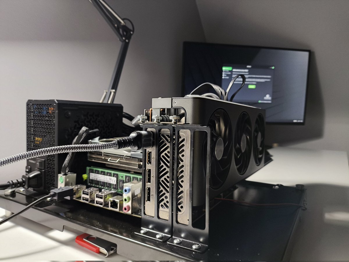 DanielParke_'s tweet photo. It's alive!!! 🤖

Early testing of the budget build has gone well, with promising results 🎉 As such, we have expanded to include some more GPUs for testing.  

Total build cost: 
RTX 3090Ti (24GB) - £1149 
RX 7900 XTX (24GB) - £1009 
RTX 2070 super (8GB) - £484 
NucBox G5 - £145.95  

Early tests with tuning showing power reductions of around 33%, while getting token speeds anywhere from 50-200 tk/s depending on the model.  

This is using a range of models, mainly the Dense/MOE Qwen-3.6 & Gemma-4 models.  

Video build guide + install script to get started with Llama.cpp/Unsloth coming soon!