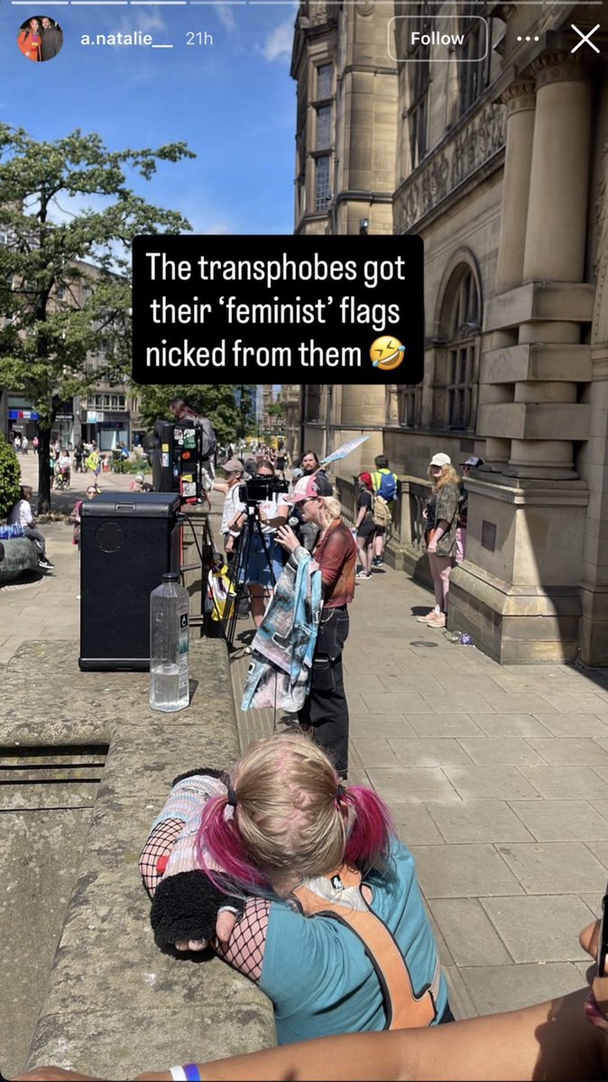JeanHatchet's tweet photo. This man is called “Jes” Jester and attends multiple Pride events. He was at the “demo” on Sunday against women’s right to single-sex services. 

He is in the foreground of this photo of another man admitting the group stole from us.

Yes - these men need to be kept out of women’s spaces because they hate us.

Yes they loathe same-sex attracted women like us. 

If they can’t tolerate us walking with a suffragette flag - you KNOW what they would do to a lone woman in a toilet who they perceived to be “hateful” in some way. 

(Stolen: one suffragette flag, one pair of sunglasses, one John Deere hat)