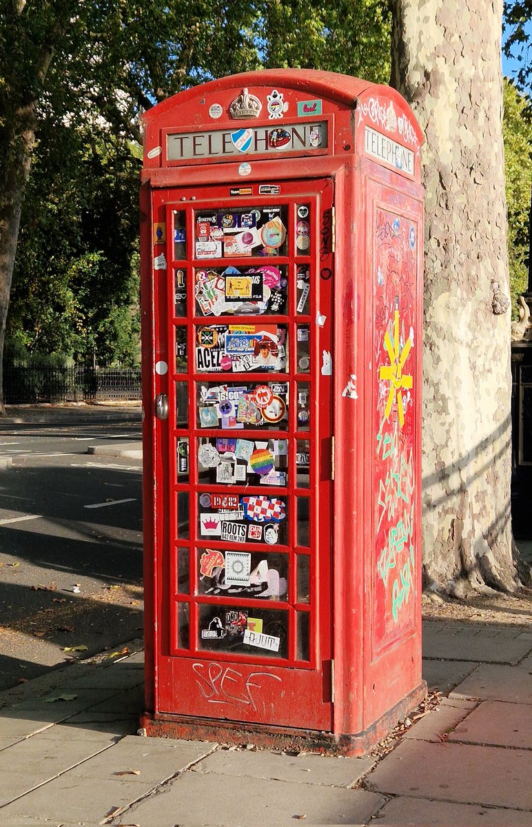 VinnieSull1van's tweet photo. On the left is the instillation of a brand new, gleaming red K6 telephone box being installed in London during the 1930s. Designed by architect Sir Giles Gilbert Scott, the red phone boxe became a symbol of Britin. On the right is what they've become. If they're not being graffitied, stickered, attacked, or being treated as a public urinal, they're being shipped off to cemeteries to rot or to be sold as ornaments. 

Not only were they removed on mass to water down British culture and uniformity, but the society of today vandalises the few we have left. ⏳️